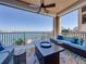 Relax on this spacious covered balcony with comfortable seating and a stunning waterfront view at 240 108Th Ave # 102, Treasure Island, FL 33706