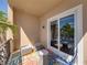 Inviting balcony seating area with a colorful rug and sliding glass door at 240 108Th Ave # 102, Treasure Island, FL 33706