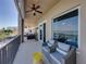 Large balcony with tile flooring features comfortable seating, a ceiling fan, and views of the marina at 240 108Th Ave # 102, Treasure Island, FL 33706