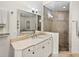 A primary bath has marble countertop sink and glass enclosed shower at 240 108Th Ave # 102, Treasure Island, FL 33706