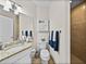 Well-lit bathroom features granite countertops, modern fixtures, and a tiled shower at 240 108Th Ave # 102, Treasure Island, FL 33706