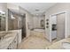 A lavish primary bath features a glass-enclosed shower, garden tub, and dual vanities at 240 108Th Ave # 102, Treasure Island, FL 33706