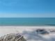 Breathtaking views of a pristine sandy beach meeting the serene ocean, inviting relaxation and seaside enjoyment at 240 108Th Ave # 102, Treasure Island, FL 33706