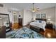 A beautiful bedroom features wood floors, a ceiling fan, a king bed and a cozy sitting area at 240 108Th Ave # 102, Treasure Island, FL 33706