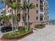 Lush landscaping and palm trees accent the exterior of this inviting condominium building at 240 108Th Ave # 102, Treasure Island, FL 33706