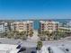 Stunning view of luxurious condos with a shared pool, lush landscaping, and convenient parking for residents and guests at 240 108Th Ave # 102, Treasure Island, FL 33706