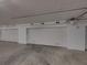 Clean, well-lit garage with multiple parking spaces and white doors at 240 108Th Ave # 102, Treasure Island, FL 33706
