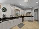 Gourmet kitchen features granite counters, stainless appliances, and beautiful tile floors at 240 108Th Ave # 102, Treasure Island, FL 33706