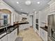 Well-equipped kitchen with black countertops, tile backsplash, and stainless steel appliances at 240 108Th Ave # 102, Treasure Island, FL 33706