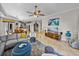 Open-concept living space showcasing stylish furniture and seamless flow to the dining and kitchen areas at 240 108Th Ave # 102, Treasure Island, FL 33706