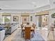 Open concept dining and living area with access to a balcony and lots of natural light at 240 108Th Ave # 102, Treasure Island, FL 33706