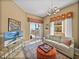 Cozy living room with a view of the balcony, stylish furnishings, and a TV at 240 108Th Ave # 102, Treasure Island, FL 33706