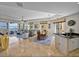 Bright living and dining area that extends to an outdoor balcony with stunning water views at 240 108Th Ave # 102, Treasure Island, FL 33706