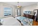 Comfortable main bedroom with exterior balcony providing water views and a decorative area rug at 240 108Th Ave # 102, Treasure Island, FL 33706