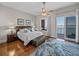 Cozy main bedroom with an exterior balcony overlooking the water and beautiful hardwood floors at 240 108Th Ave # 102, Treasure Island, FL 33706