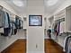 A beautiful walk-in closet is customized with storage and closet organization at 240 108Th Ave # 102, Treasure Island, FL 33706