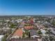 Aerial view showcases the townhomes near a pond and a shopping area, highlighting the community's convenient location at 2402 W Azeele St # 423, Tampa, FL 33609