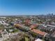 Stunning aerial view of a townhome community with lush landscaping and a beautiful city skyline in the distance at 2402 W Azeele St # 423, Tampa, FL 33609
