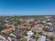 An aerial view shows the townhome community with nearby streets, buildings, and cityscape, offering urban living at 2402 W Azeele St # 423, Tampa, FL 33609