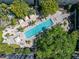 Aerial view of the community pool surrounded by lush landscaping and comfortable lounge areas at 2402 W Azeele St # 423, Tampa, FL 33609