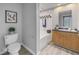Well-lit bathroom with vanity, toilet, and shower-tub combo at 2402 W Azeele St # 423, Tampa, FL 33609