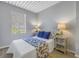 Comfortable bedroom features a decorative ceiling, window, and stylish blue and white accents at 2402 W Azeele St # 423, Tampa, FL 33609