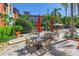 Outdoor common area with tables, chairs, umbrellas, and a grill creates a welcoming space for relaxation at 2402 W Azeele St # 423, Tampa, FL 33609