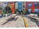 Outdoor common area boasts picnic tables and a BBQ grill against colorful building facades at 2402 W Azeele St # 423, Tampa, FL 33609