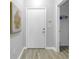 Entryway featuring hardwood floors, a white front door, and access to a storage closet at 2402 W Azeele St # 423, Tampa, FL 33609