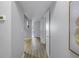 Hallway with open doorways and light hardwood flooring at 2402 W Azeele St # 423, Tampa, FL 33609