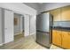 Kitchen featuring stainless steel appliances, light wood cabinets, and access to a bathroom at 2402 W Azeele St # 423, Tampa, FL 33609