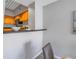 Pass-through kitchenette featuring modern appliances, wood cabinets and a breakfast bar at 2402 W Azeele St # 423, Tampa, FL 33609