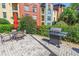 Community outdoor grill area with lush landscaping, dining table, and seating, perfect for entertaining guests at 2402 W Azeele St # 423, Tampa, FL 33609