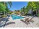 Inviting community pool featuring comfortable lounge chairs, lush tropical landscaping, and beautiful multi-story condos at 2402 W Azeele St # 423, Tampa, FL 33609