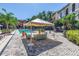 Inviting pool area features a shaded lounge space and lush tropical landscaping at 2402 W Azeele St # 423, Tampa, FL 33609