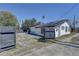 Backyard featuring a privacy fence, with solar panels on the roof, and a seating area at 315 40Th S St, St Petersburg, FL 33711