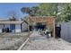 Backyard area with a pergola, Adirondack chairs, privacy fence, and shed at 315 40Th S St, St Petersburg, FL 33711