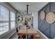 Stylish dining room with a rustic wood table, contemporary chandelier, and decorative wall accents at 315 40Th S St, St Petersburg, FL 33711