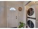 Functional entryway with stacked washer and dryer, and a decorative hat at 315 40Th S St, St Petersburg, FL 33711