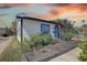 Charming exterior view of house with landscaped garden, blue door and black trim at 315 40Th S St, St Petersburg, FL 33711