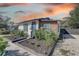 Home exterior with landscaping, black trim, and wooden siding at 315 40Th S St, St Petersburg, FL 33711