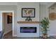 Modern electric fireplace set against shiplap wall, complemented by a wooden mantel and minimalist decor at 315 40Th S St, St Petersburg, FL 33711