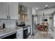 Modern kitchen features stainless appliances, granite counters, and open dining area at 315 40Th S St, St Petersburg, FL 33711