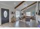 Inviting living room featuring vaulted ceilings, wood beams, a modern light fixture, and elegant decor at 315 40Th S St, St Petersburg, FL 33711