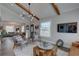 Cozy living room with vaulted ceilings, wood beams, modern lighting, and comfortable seating arrangement at 315 40Th S St, St Petersburg, FL 33711