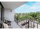 Relaxing balcony with seating, offering pleasant views of the surrounding neighborhood at 3211 W Swann Ave # 502, Tampa, FL 33609