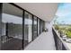 Long balcony with seating with views of the treeline and neighborhood at 3211 W Swann Ave # 502, Tampa, FL 33609