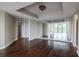 Bedroom featuring wood floors, ceiling detail and closet with mirrored wall at 3211 W Swann Ave # 502, Tampa, FL 33609