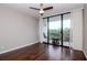 Bedroom featuring hardwood floors and sliding glass doors to a balcony with seating at 3211 W Swann Ave # 502, Tampa, FL 33609