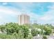 Distant city views from the property offering a glimpse of the urban landscape beyond the lush treetops at 3211 W Swann Ave # 502, Tampa, FL 33609